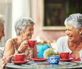 three-happy-ladies-having-lunch_social-wellness three-happy-ladies-having-lunch_social-wellness